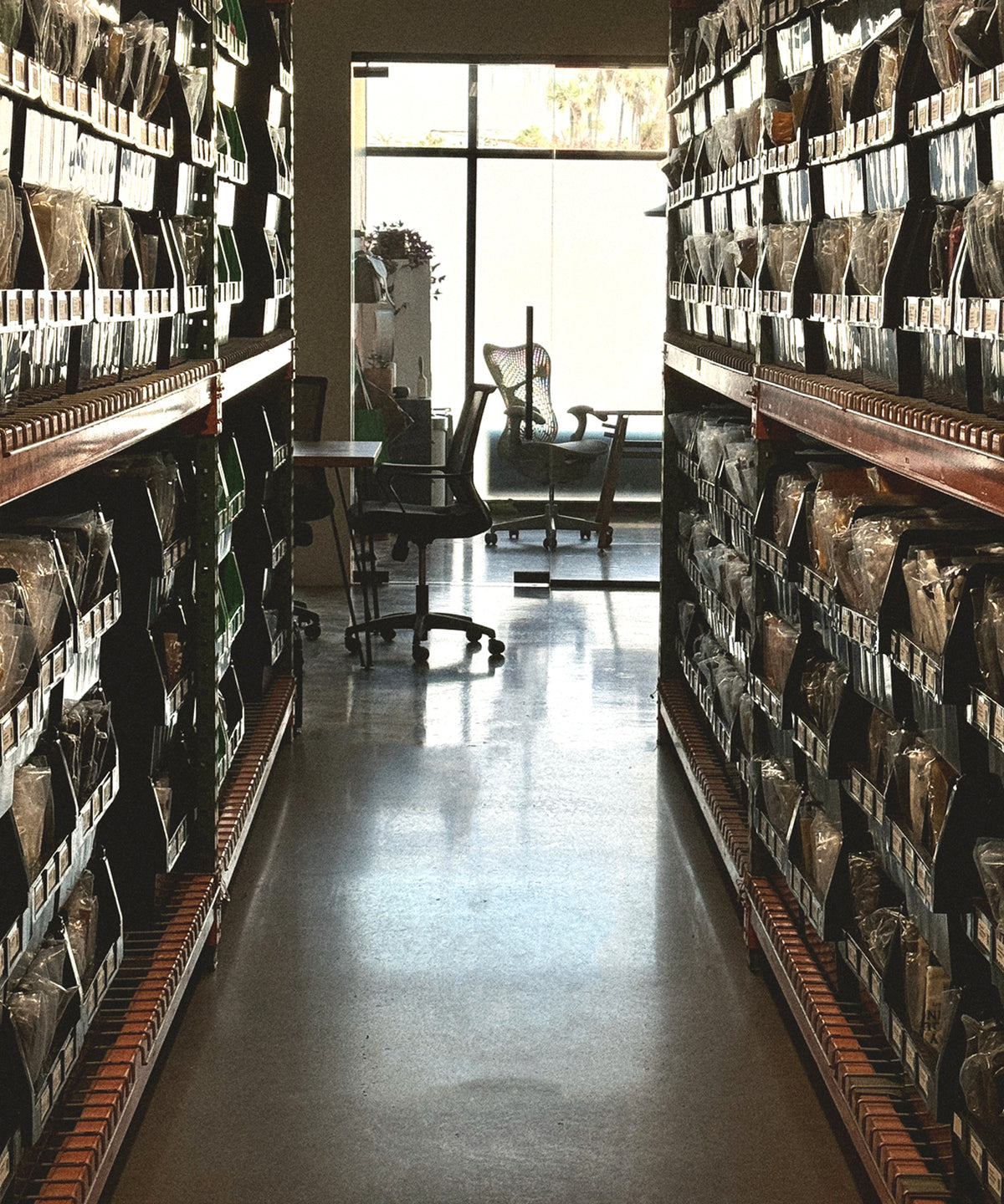 Aisle of shelved merch inventory ready to ship from the Superluxe Merch shop in Phoenix