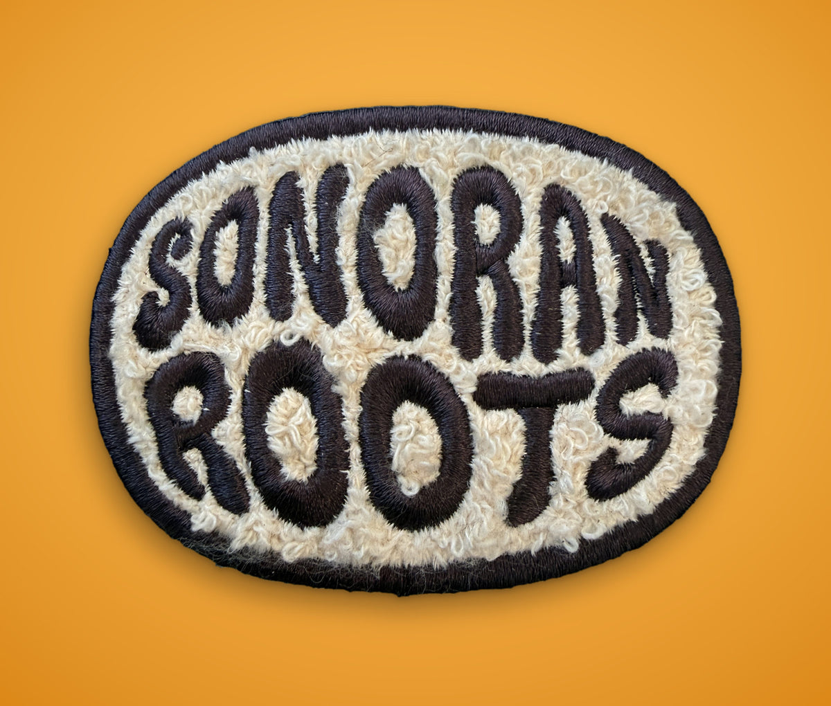 Custom chenille patch with Sonoran Roots lettering