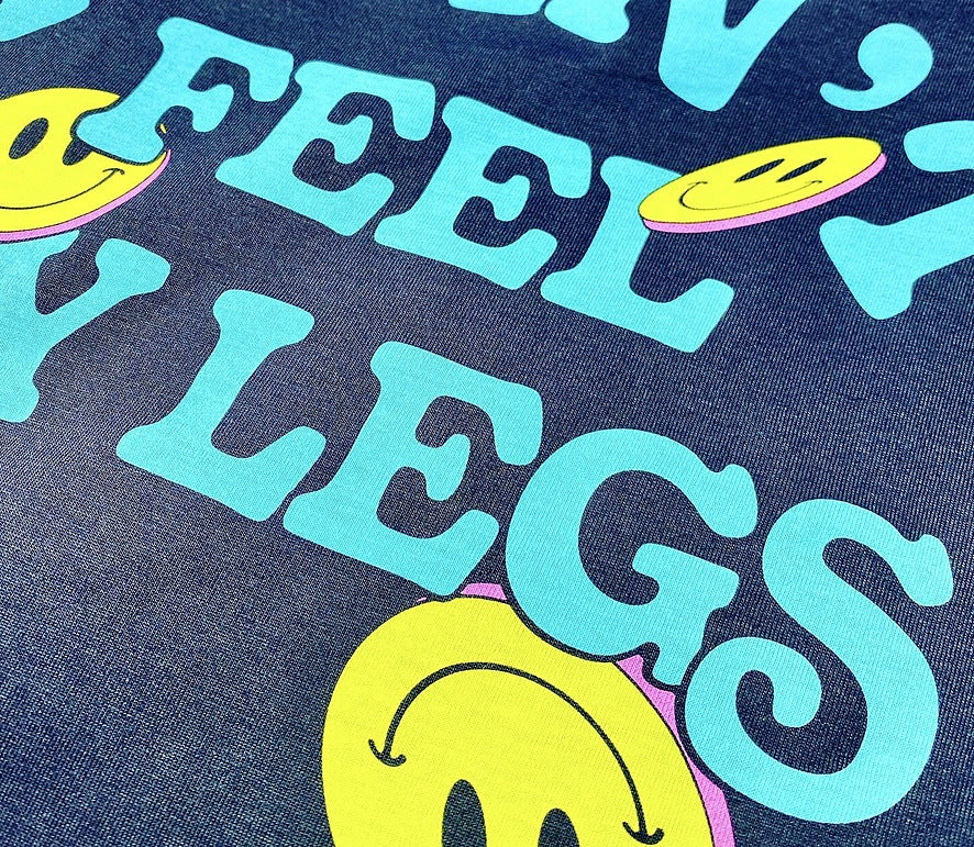 Discharge ink print on navy shirt, soft hand cyan and yellow graphics with the fabric texture showing through