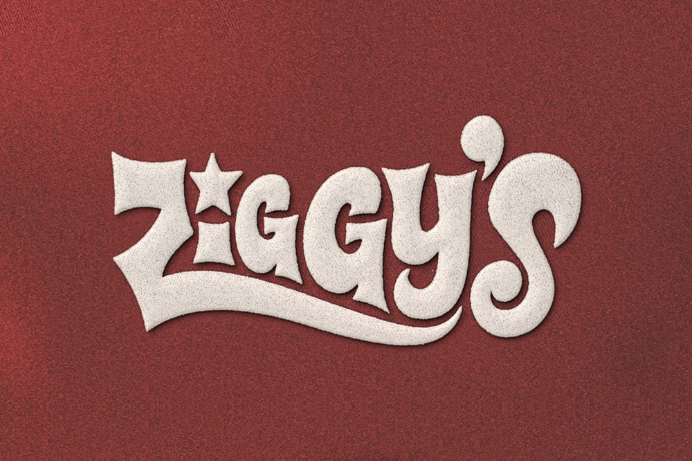 Close-up of white Ziggy's script heat transfer on red fabric