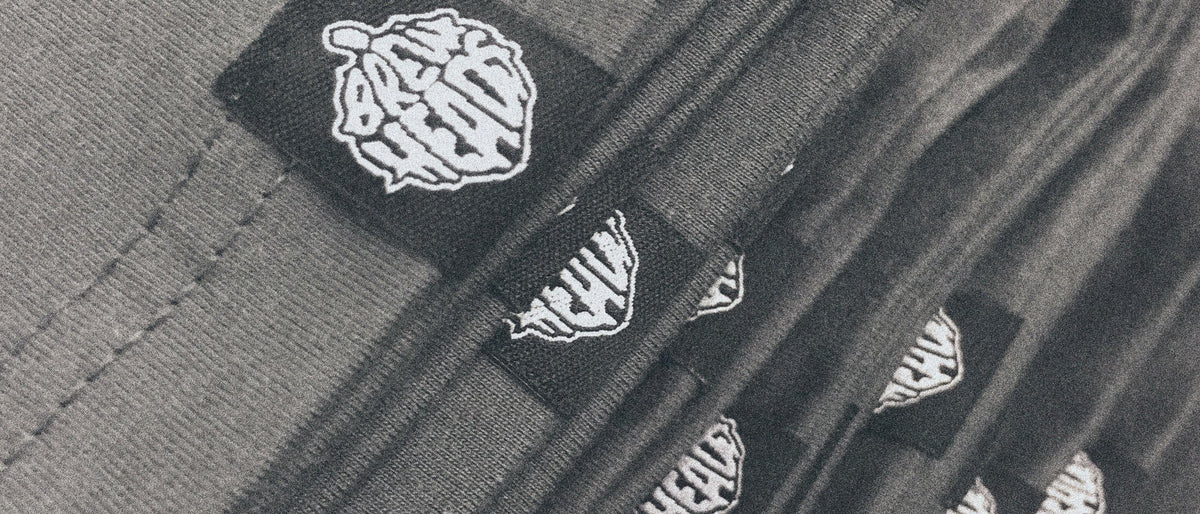 Custom woven hem tag sewn onto a garment hem