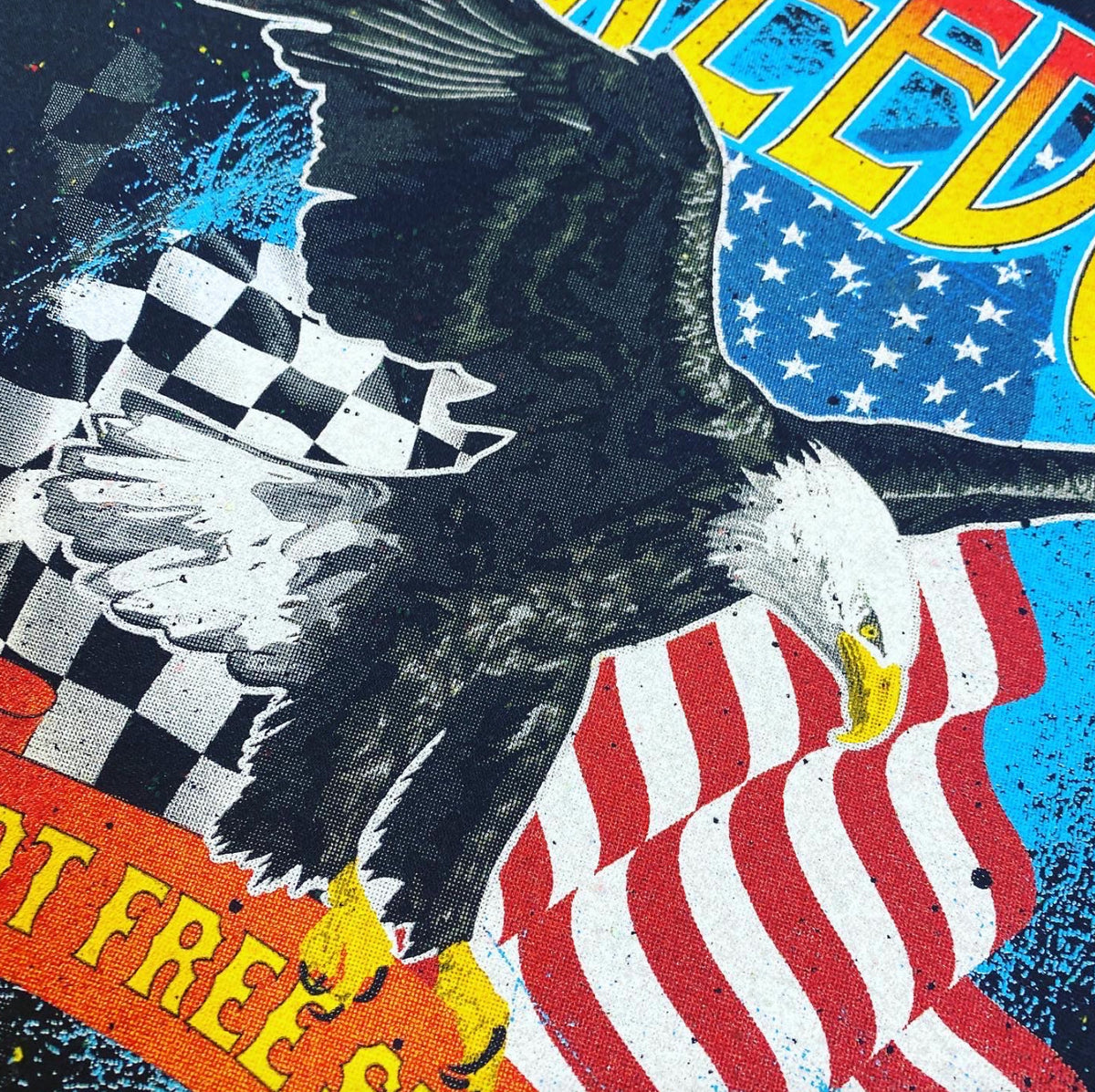 Plastisol screen print of an eagle and flags on black fabric