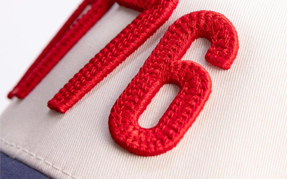 Close-up of raised red puff embroidery on a trucker hat
