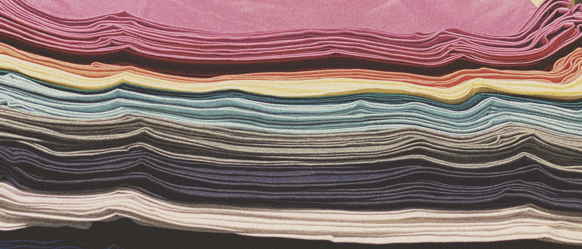 Stacks of folded t-shirts in many colors, ready to color-code VBS teams