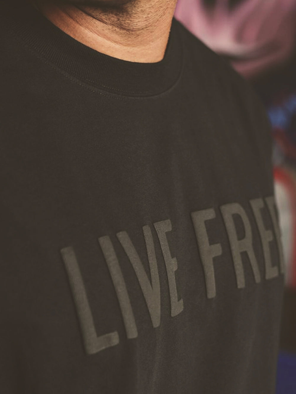 Tonal black puff print on a black tee