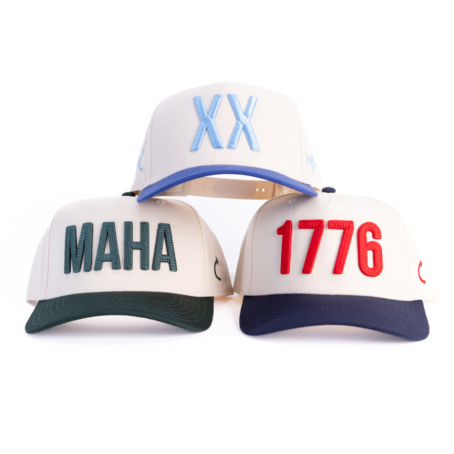 Three cream puff-embroidered caps with royal blue, green and navy brims